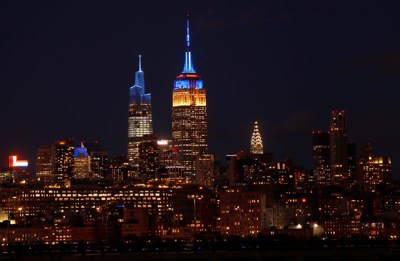The Empire State Building is lit in the colors of the flag of Ukraine on Feb. 25, 2022, as seen from Jersey City