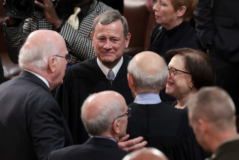 Supreme Court Chief Justice John Roberts (C) talks to fellow Justices and lawmakers as they attend U.S. President Joe Biden's State of the Union address during a joint session of Congress in the U.S. Capitol's House Chamber March 01, 2022 in Washington, D.C