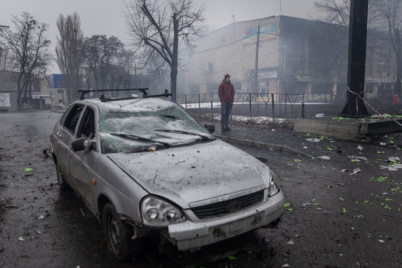 A man looks over rubble and a damaged vehicle across the street from the Kyiv TV Tower on March 02, 2022 in Kyiv, Ukraine. The country's president, Volodymyr Zelensky, said that at least five people were killed when a projectile struck the area yesterday, which is adjacent to the Babyn Yar Holocaust Memorial Center.
