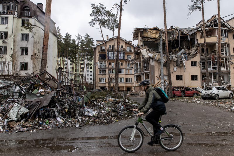 A man rides his bike past destroyed buildings on March 03, 2022 in Irpin, Ukraine. Russia continues assault on Ukraine's major cities, including the capital Kyiv, a week after launching a large-scale invasion of the country