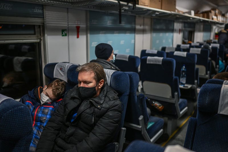 Father and son sleep as others receive medical assistance inside a train wagon transformed for medical transport on March 03, 2022 in Przemysl, Poland. Around a dozen children with chronic illnesses who were being treated in a Kharkiv hospital were transported by train from Mosciska, Ukraine to Poland today. They are among the hundreds of thousands of people who have fled Ukraine into Poland as Russia continues its invasion of Ukraine. (Photo by Omar Marques/Getty Images)