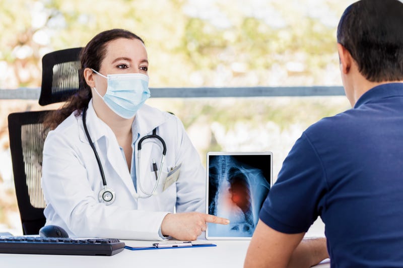 female doctor using a digital tablet during a consultation with a man