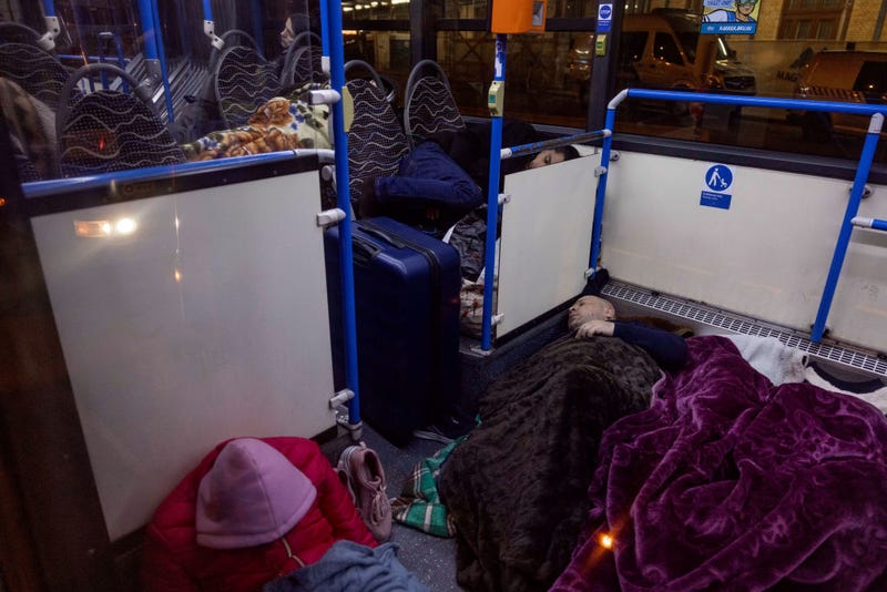 FILE - Ukrainian refugees at the Western Railway Station sleep in warming buses for the night as they flee Ukraine on March 7, 2022 in Budapest, Hungary. Hungary has been the second-most-popular destination for refugees fleeing Ukraine after Russia began a large-scale attack on Feb. 24, 2022.