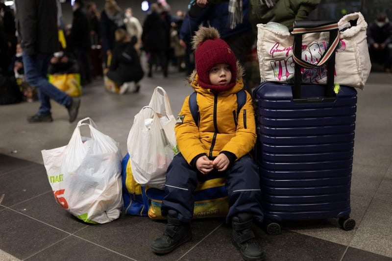 A Ukrainian boy fleeing his war-torn country with his family