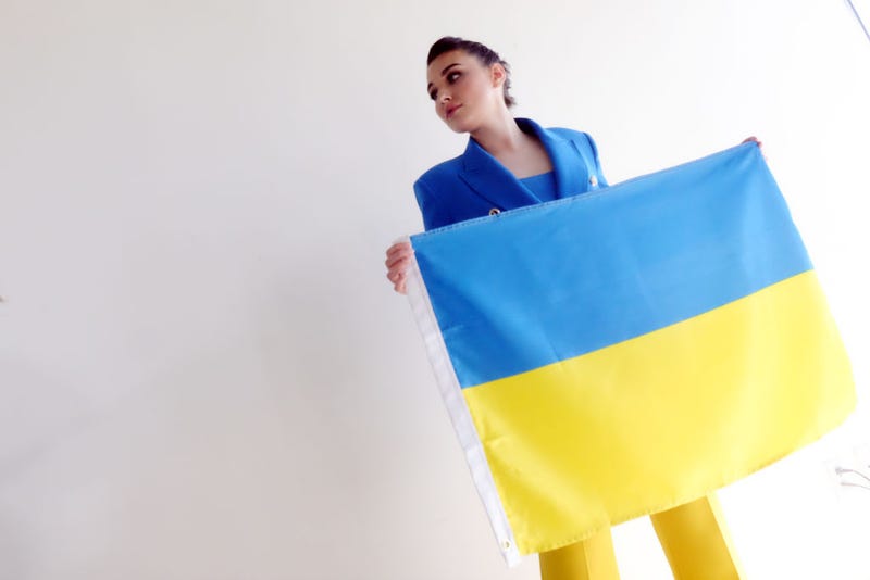 Miss Ukraine 2018 Veronika Didusenko holds a Ukrainian flag at a press conference with Gloria Allred on March 08, 2022 in Los Angeles. Didusenko discussed the impact of the Ukrainian war on mothers and children fleeing Ukraine.