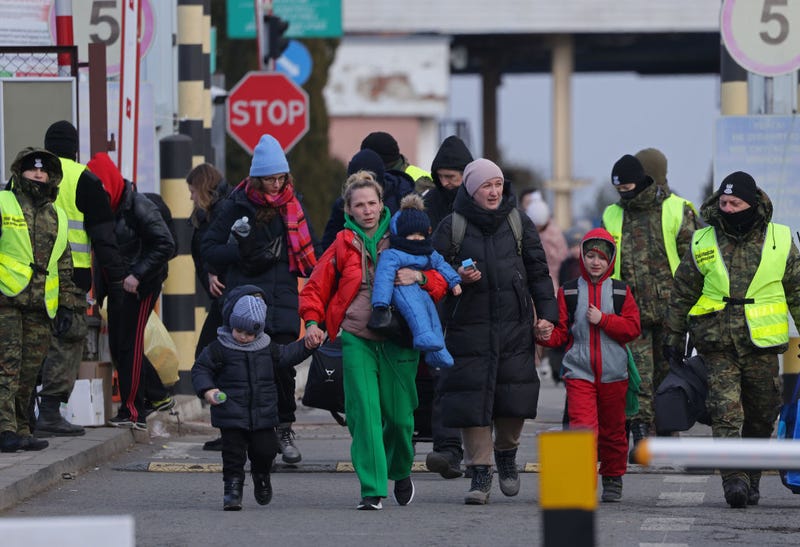 Women and children fleeing war-torn Ukraine walk into Poland at the Korczowa border crossing on March 10, 2022 at Korczowa, Poland. Over one million people have arrived in Poland from Ukraine since the Russian invasion of February 24, and while many are now living with relatives who live and work in Poland, others are journeying onward to other countries in Europe.
