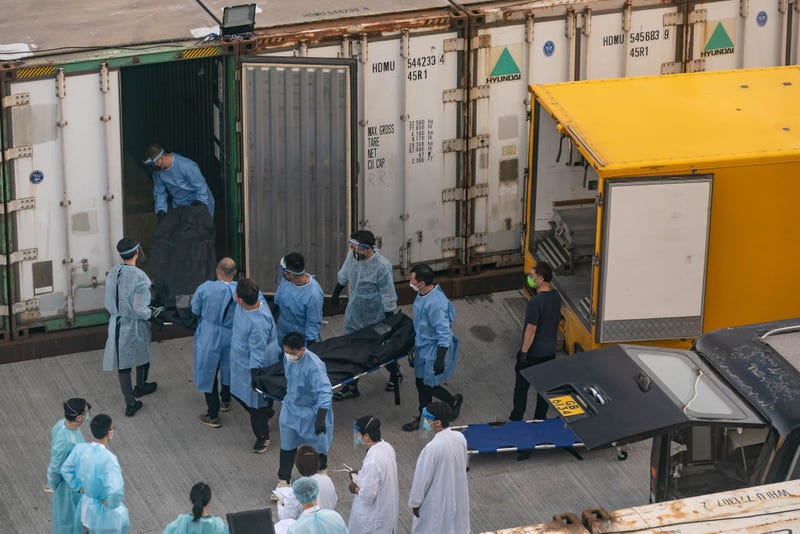 Workers transfer a body of a deceased person at a Mortuary on March 7, 2022 in Hong Kong, China.
