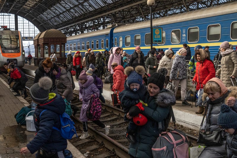 Passengers depart the railway station after disembarking trains from the east on March 11, 2022 in Lviv, Ukraine