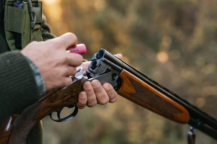 man loading a hunting rifle 
