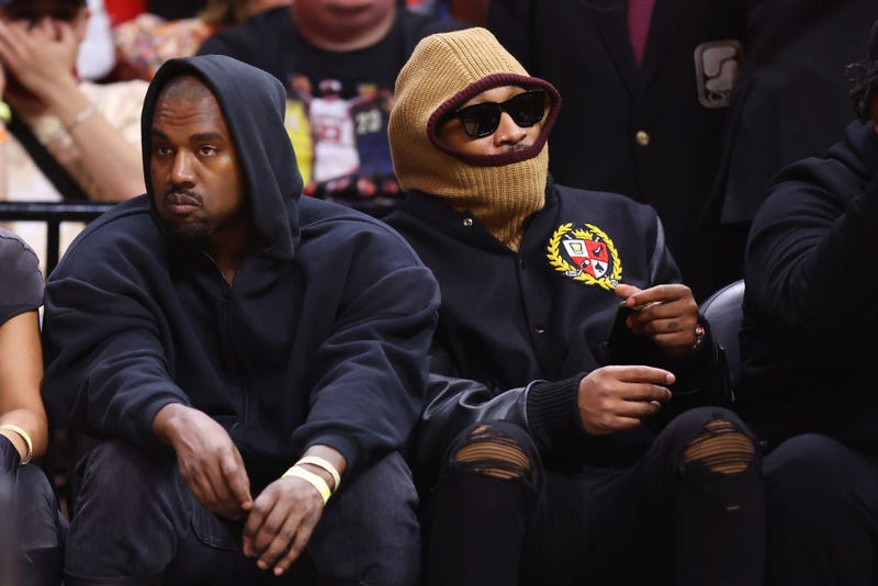 Rappers Kanye West (L) and Future look on courtside during the first half between the Miami Heat and the Minnesota Timberwolves at FTX Arena on March 12, 2022 in Miami, Florida.