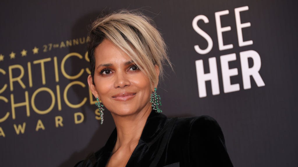 Halle Berry looks disco fever-hot in plunging gold lamé jumpsuit