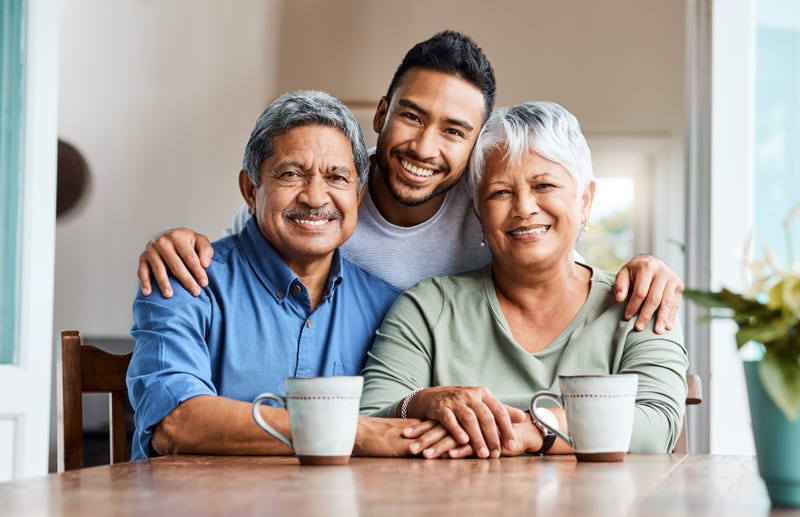 Shot of a young son spending time with his parents at home - stock photo