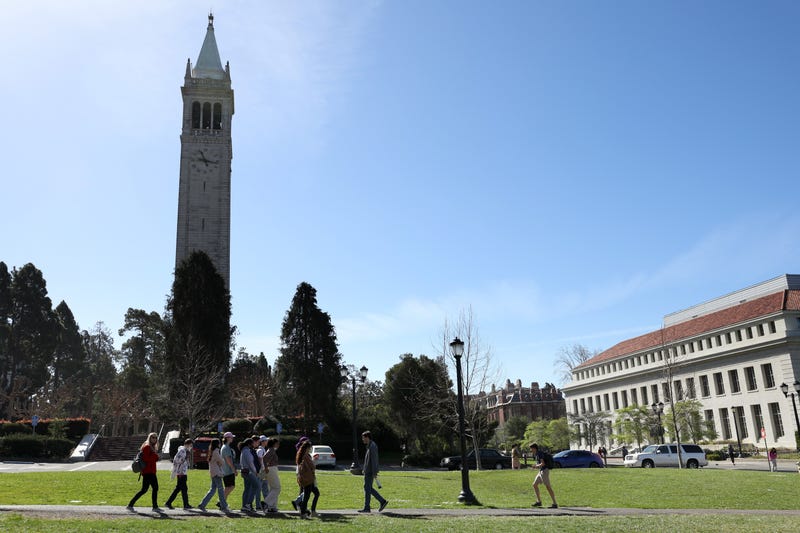 A group walks by Sather Tower on the UC Berkeley campus on March 14, 2022 in Berkeley, California. 