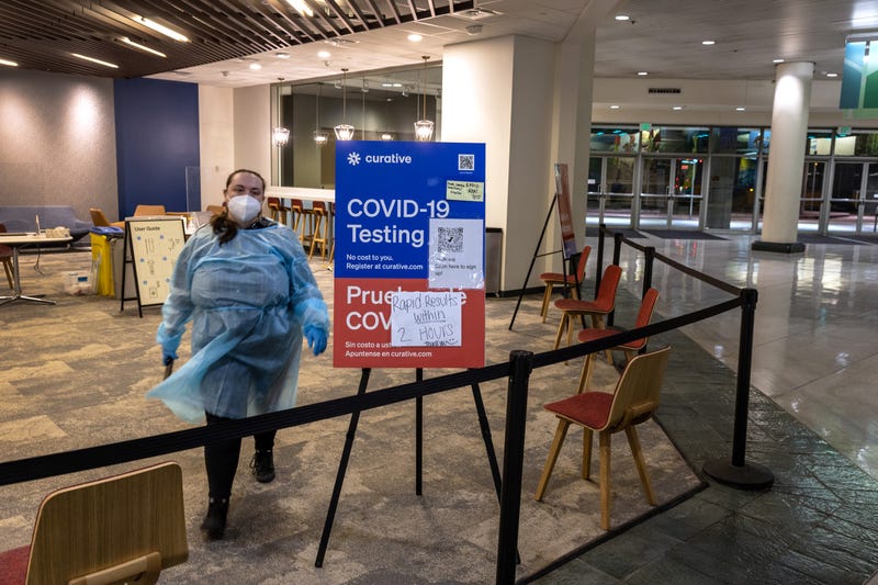 A health worker waits at an empty COVID-19 testing center at the Washington State Convention Center in Seattle, Washington. Once crowded, testing sites are mostly now devoid of patients.
