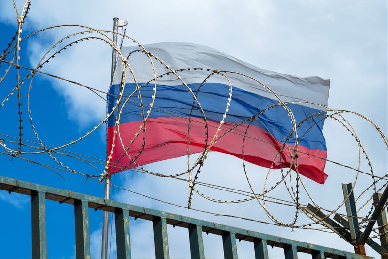Russian flag behind barbed wire