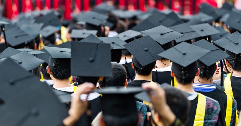 Graduates standing at their commencement ceremony.