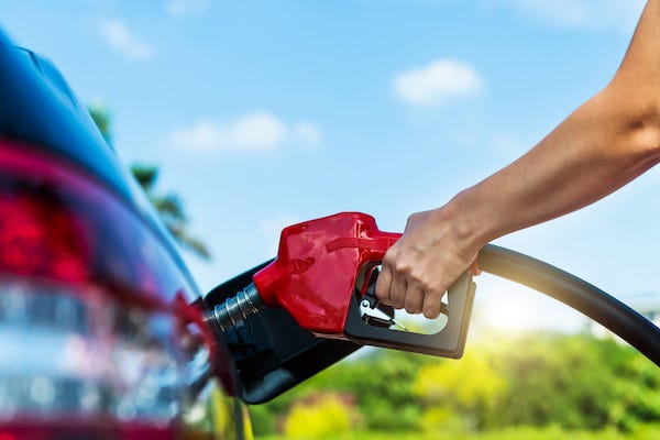Woman filling her car up with gas