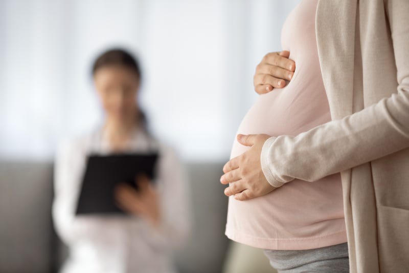Stock photo of pregnant woman with doctor