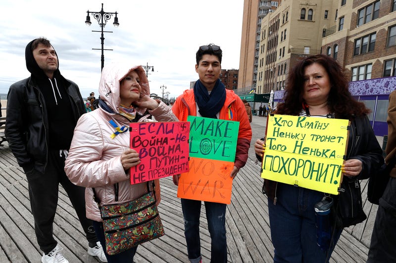 Rally participants listen to mostly Russian speakers denounce the war in the Ukraine on March 20, 2022 in the Brighton Beach section of the Brooklyn borough of New York City. As the Russian invasion of Ukraine escalates with intense shelling and targeting of civilians, many Russians have fled to neighboring countries for fear of political retribution and as a way to protest the war.