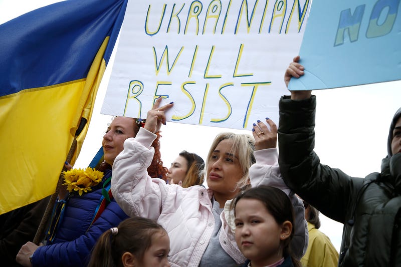 Rally participants listen to mostly Russian speakers denounce the war in the Ukraine on March 20, 2022 in the Brighton Beach section of the Brooklyn borough of New York City. As the Russian invasion of Ukraine escalates with intense shelling and targeting of civilians, many Russians have fled to neighboring countries for fear of political retribution and as a way to protest the war.