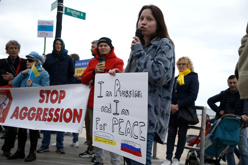Rally participants listen to a Russian speaker denounce the war in the Ukraine on March 20, 2022 in the Brighton Beach section of the Brooklyn borough of New York City. As the Russian invasion of Ukraine escalates with intense shelling and targeting of civilians, many Russians have fled to neighboring countries for fear of political retribution and as a way to protest the war. 