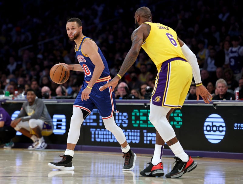 Stephen Curry #30 of the Golden State Warriors dribbles in front of LeBron James #6 of the Los Angeles Lakers during a 124-116 Lakers win at Crypto.com Arena on March 05, 2022 in Los Angeles, California.