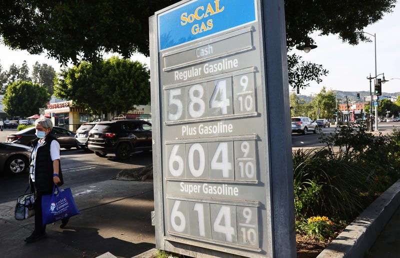 A pedestrian walks past a gas station advertising gas prices in Los Angeles, California.