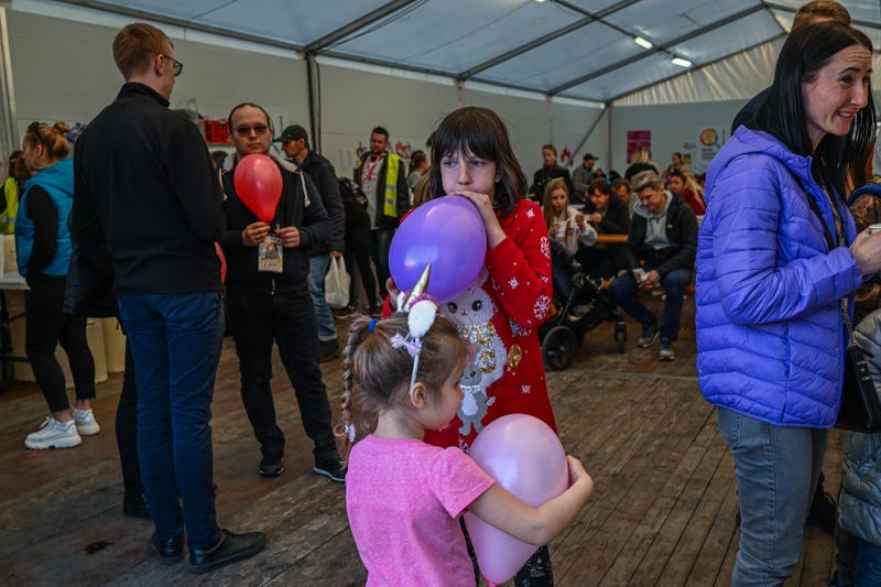 Children who fled the war in Ukraine plays with balloons inside a tent managed by the World Central Kitchen NGO next to the train station on March 29, 2022 in Krakow, Poland