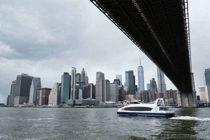 The Manhattan skyline looms over the East River in New York City. 