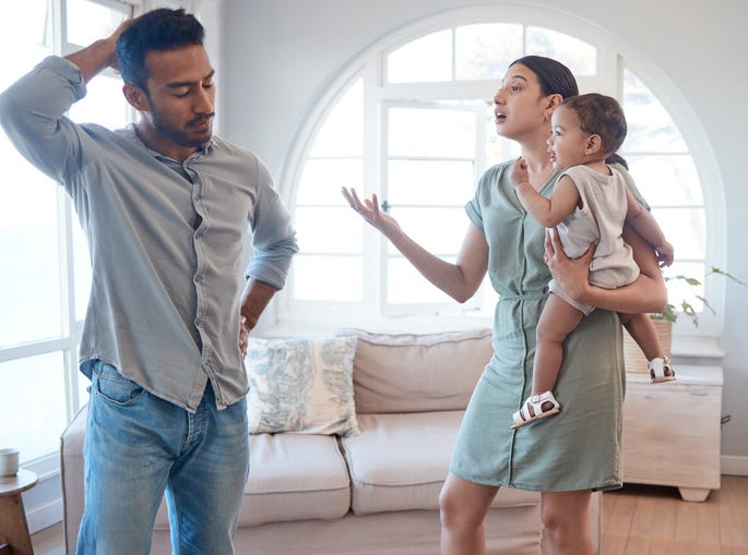 Young couple with a child stressed about having kids.