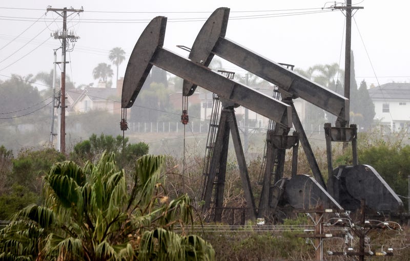 An oil pumpjack (R) operates as another (C) stands idle on March 28, 2022 in Los Angeles, California.