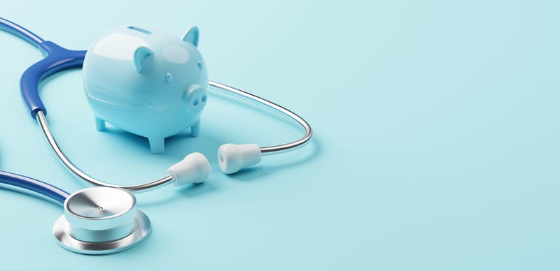 Piggy bank and stethoscope representing health care costs. 