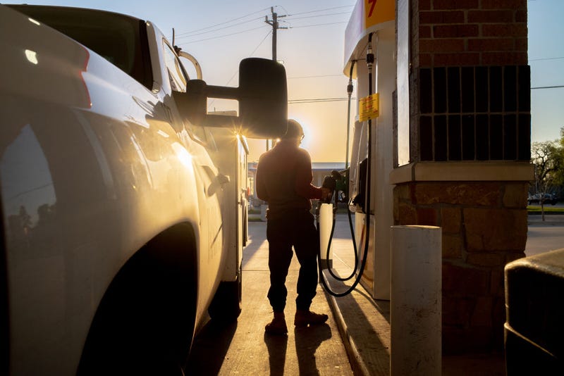 Man with truck by gas pump