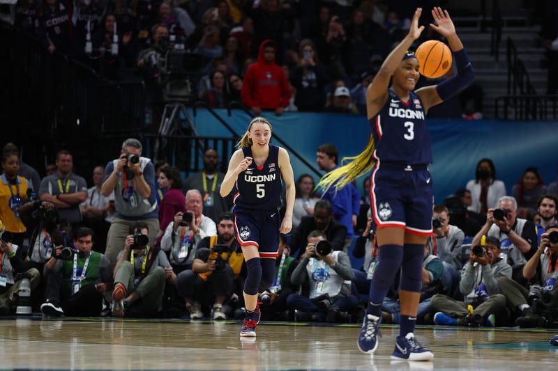 Paige Bueckers and Aaliyah Edwards of the UConn Huskies celebrate after defeating the Stanford Cardinal 63-58 in the Final Four at Minneapolis, 4/1/22.