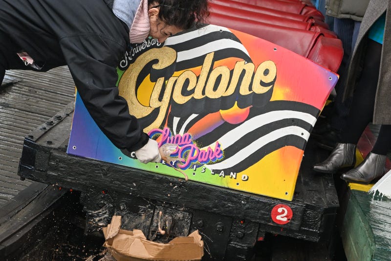 New York State Senator Diane Savino christens the cyclone by breaking an egg cream over it on the Luna Park opening day of the season at Coney Island.