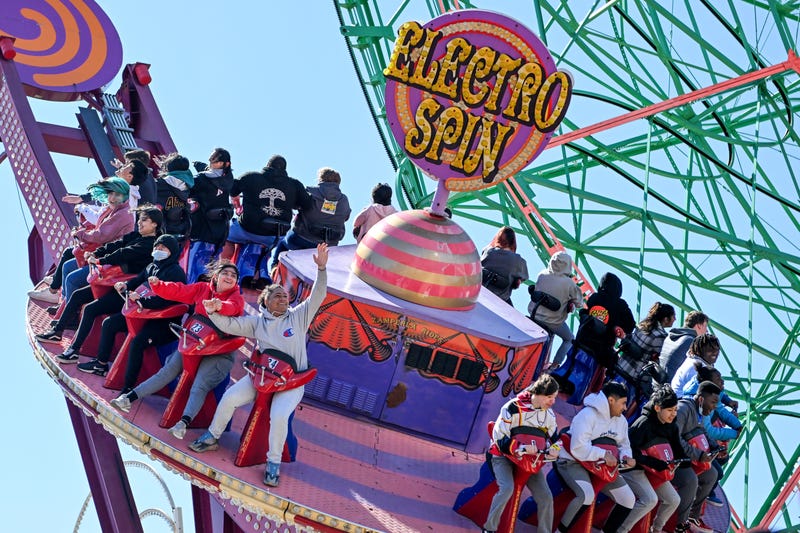 People ride the Electro Spin at Luna Park on the opening day of the season at Coney Island on April 2, 2022.