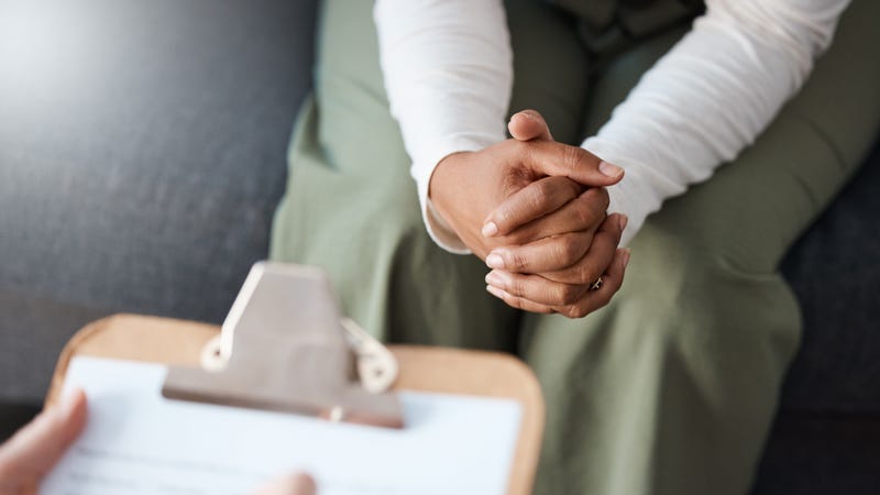 A woman speaks to a counselor.