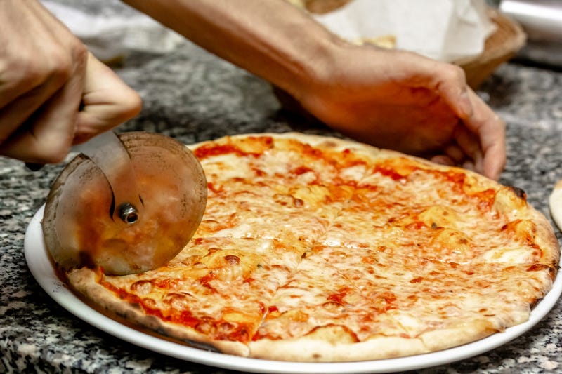 Man cutting a pizza