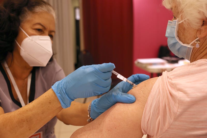 Registered Nurse Orlyn Grace (L) administers a COVID-19 booster vaccination to Jeanie Merriman (R) at a COVID-19 vaccination clinic on April 06, 2022 in San Rafael, California. 