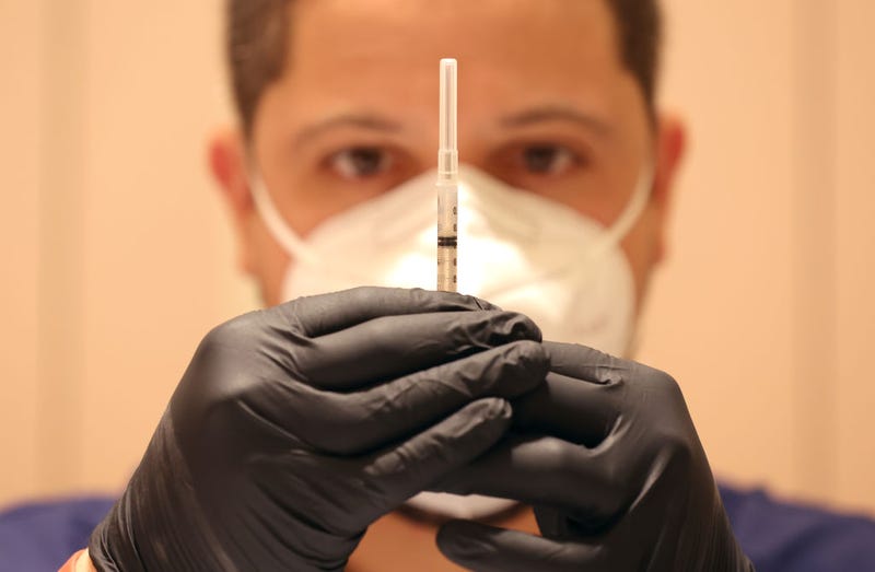 Jatniel Hernandez fills syringes with COID-19 vaccine booster shots at a COVID-19 vaccination clinic on April 06, 2022 in San Rafael, California. 