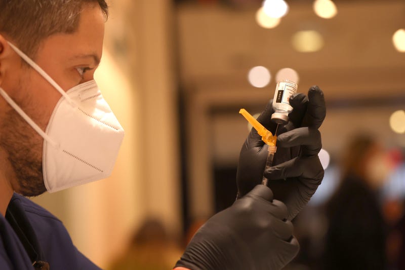 Jatniel Hernandez fills syringes with COID-19 vaccine booster shots at a COVID-19 vaccination clinic on April 06, 2022 in San Rafael, California.