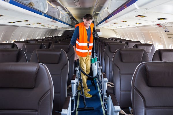 Man cleaning an airplane after a flight