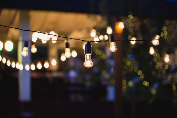Outdoor string lights hanging on a line in backyard