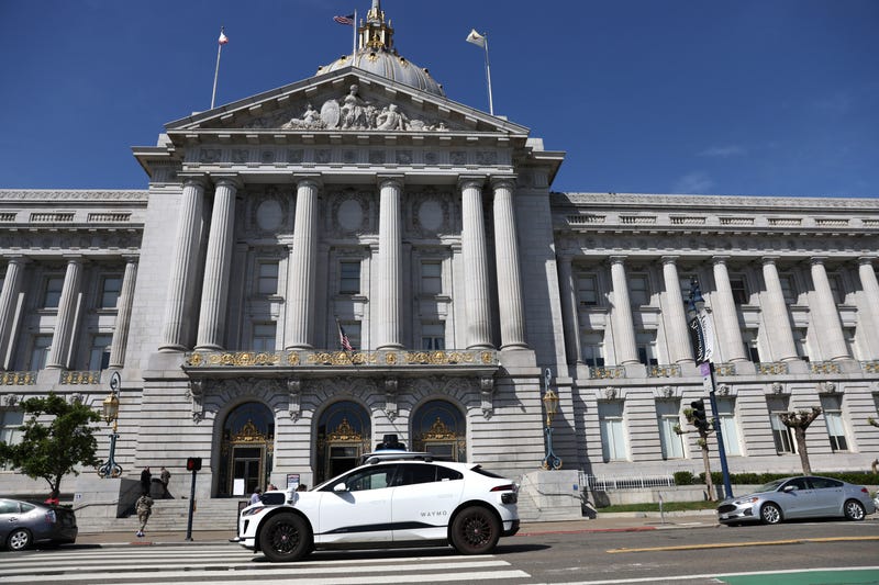A Waymo autonomous vehicle drives by San Francisco City Hall on April 11, 2022 in San Francisco, California
