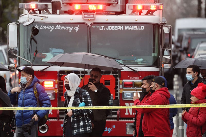 Onlookers watch as police and emergency responders gather at the site of a reported shooting of multiple people outside of the 36 St subway station on April 12, 2022 in the Brooklyn borough of New York City.