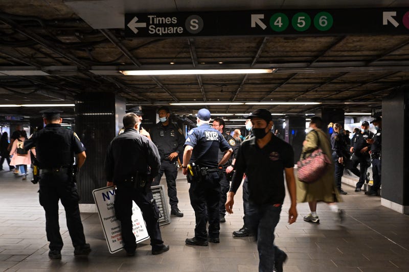 NYPD officers stand near the 4/5/6 lines at Grand Central Station