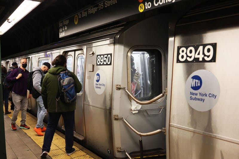 People prepare to enter the R train in Brooklyn on April 13, 2022.