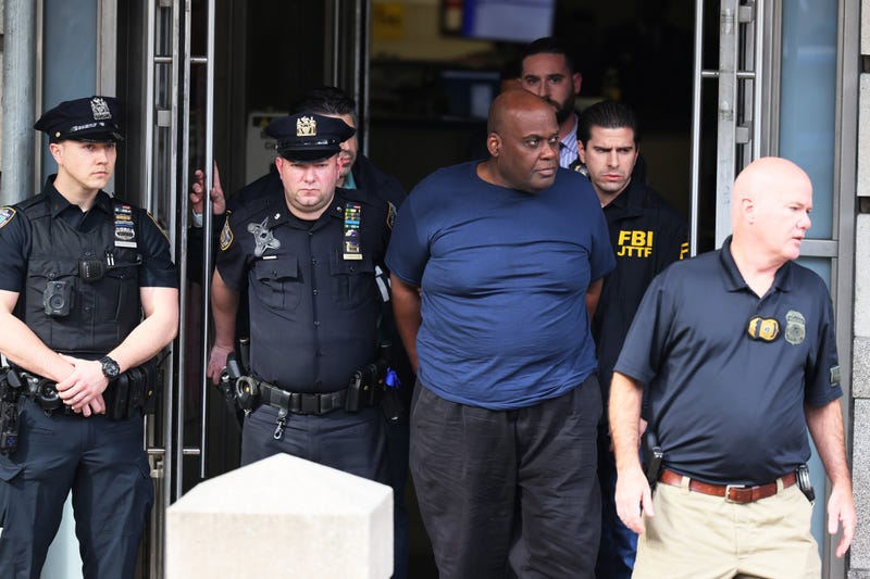 Suspect Frank James is led by police from the Ninth Precinct stationhouse in Manhattan on April 13, 2022 after being arrested in the mass shooting at the 36th Street subway station in Sunset Park