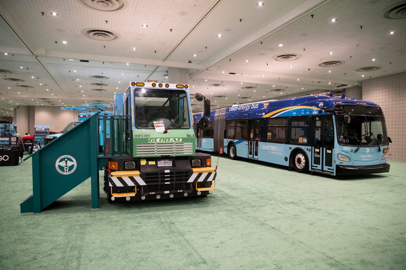 An electric garbage truck and an electric bus are on display during the press preview for the International Auto Show at the Jacob Javits Convention Center on April 13, 2022 in New York City.