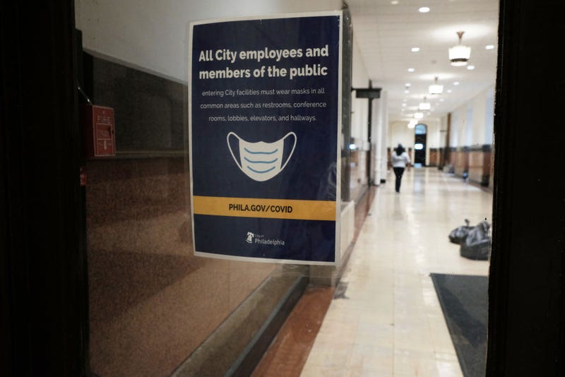 A sign on a door asks people to wear masks in downtown on April 14, 2022 in Philadelphia, Pennsylvania. 
